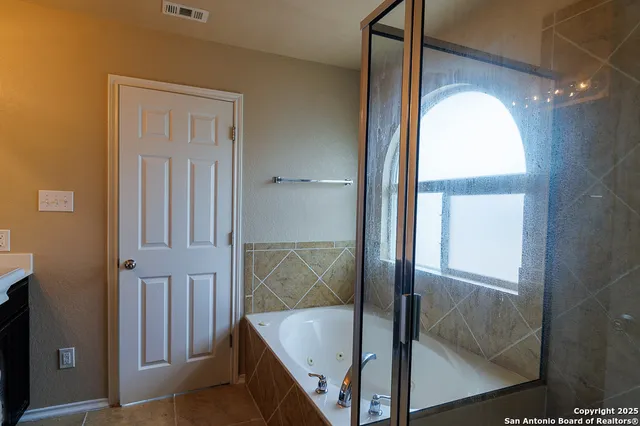 a bathroom with a tub and shower