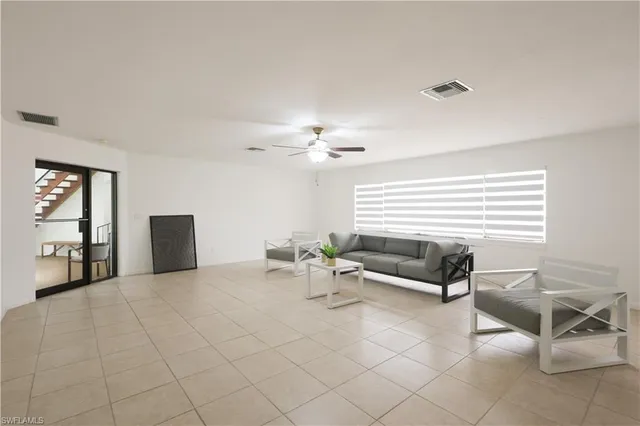 a living room with furniture and white walls