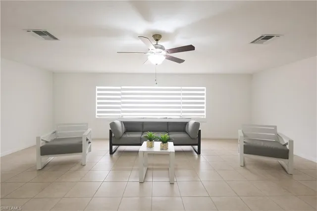 a dining room with furniture and a potted plant