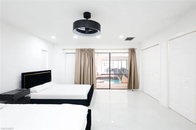 a bedroom with a large bed and a large window