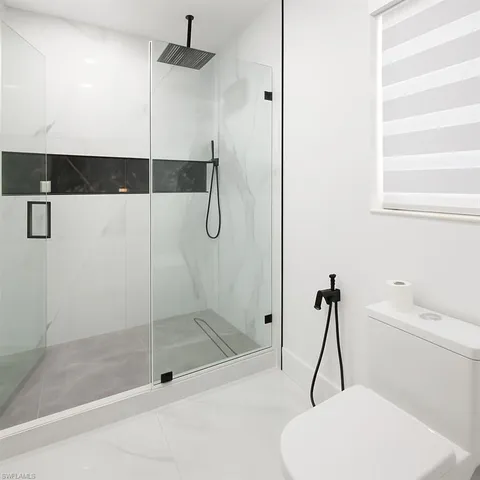 a bathroom with a shower and a toilet