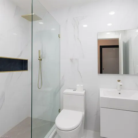 a bathroom with a toilet a sink and shower