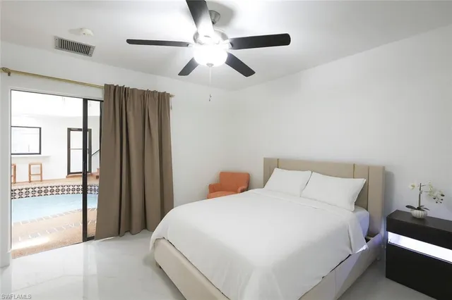 a bedroom with a large bed and a chandelier