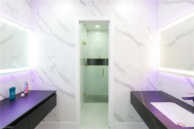 a bathroom with a tub sink and mirror