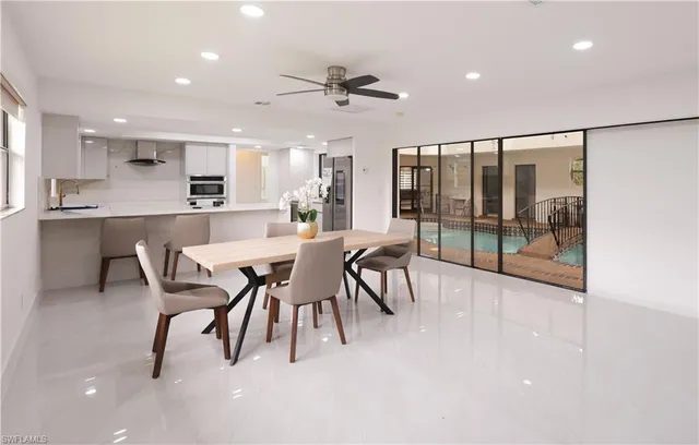 a large kitchen with a table and chairs