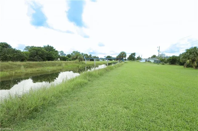 a view of a lake with houses in the back