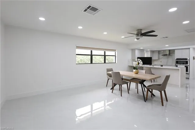 a view of a dining room with furniture and a chandelier