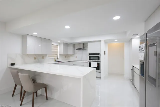a kitchen with refrigerator and cabinets