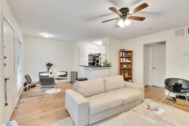 a living room with furniture a rug and a chandelier