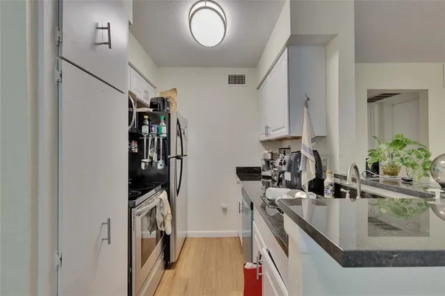 a view of a kitchen with a sink and dishwasher