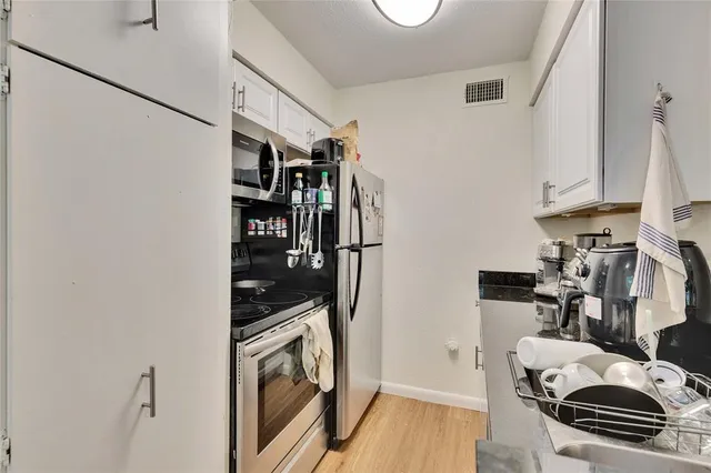 a view of a kitchen with appliances and cabinets