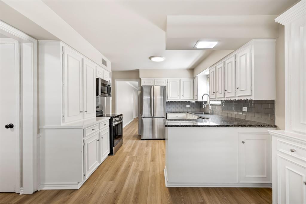 5921 Preston Road University Park, TX 75205 - Photo 11 of 37 a kitchen with stainless steel appliances granite countertop a stove a sink dishwasher and a refrigerator