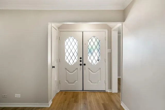 a view of front door with wooden floor