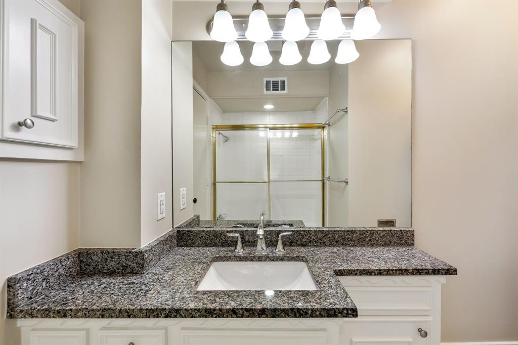 5921 Preston Road University Park, TX 75205 - Photo 23 of 37 a bathroom with a granite countertop sink and a mirror
