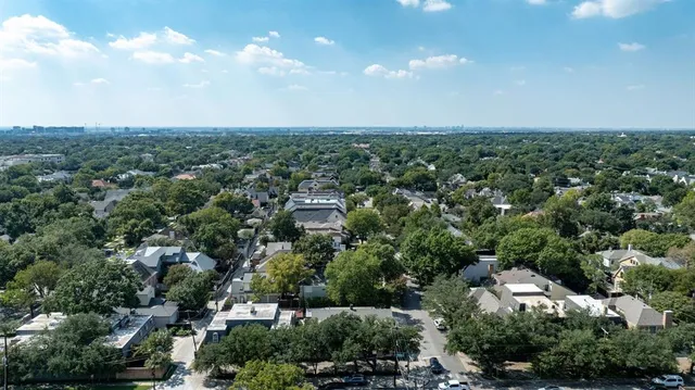 an aerial view of a house with a yard and lake view