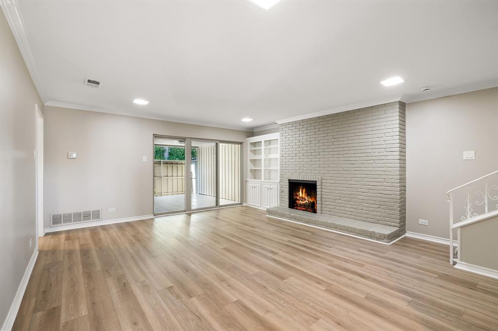 5921 Preston Road University Park, TX 75205 - Photo 4 of 37 an empty room with wooden floor and fireplace
