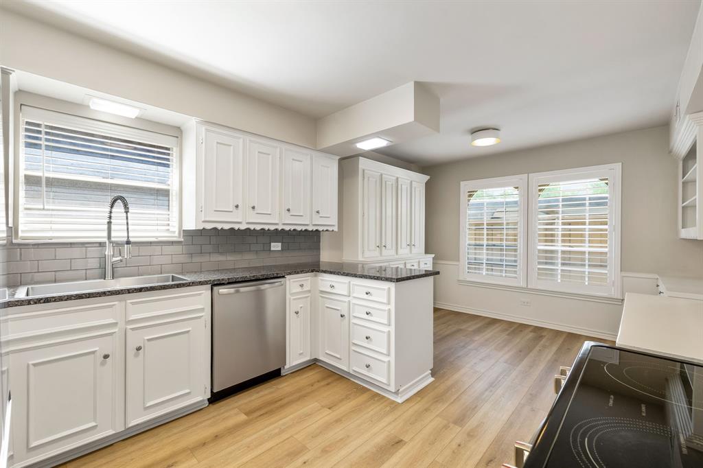 5921 Preston Road University Park, TX 75205 - Photo 9 of 37 a kitchen with granite countertop white cabinets and white appliances