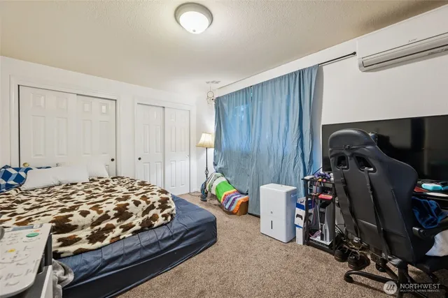 a bedroom with bed and a closet