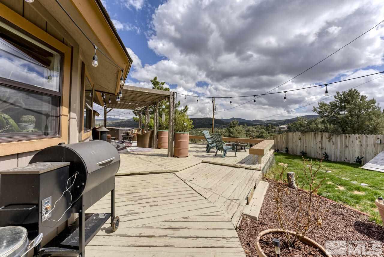 2330 Enterprise Road Reno, NV 89521 - Photo 17 of 40 a view of a patio with table and chairs with wooden floor