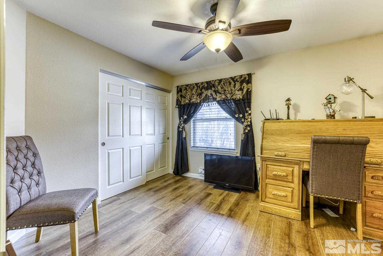 2330 Enterprise Road Reno, NV 89521 - Photo 20 of 40 a living room with a bed furniture and a wooden floor