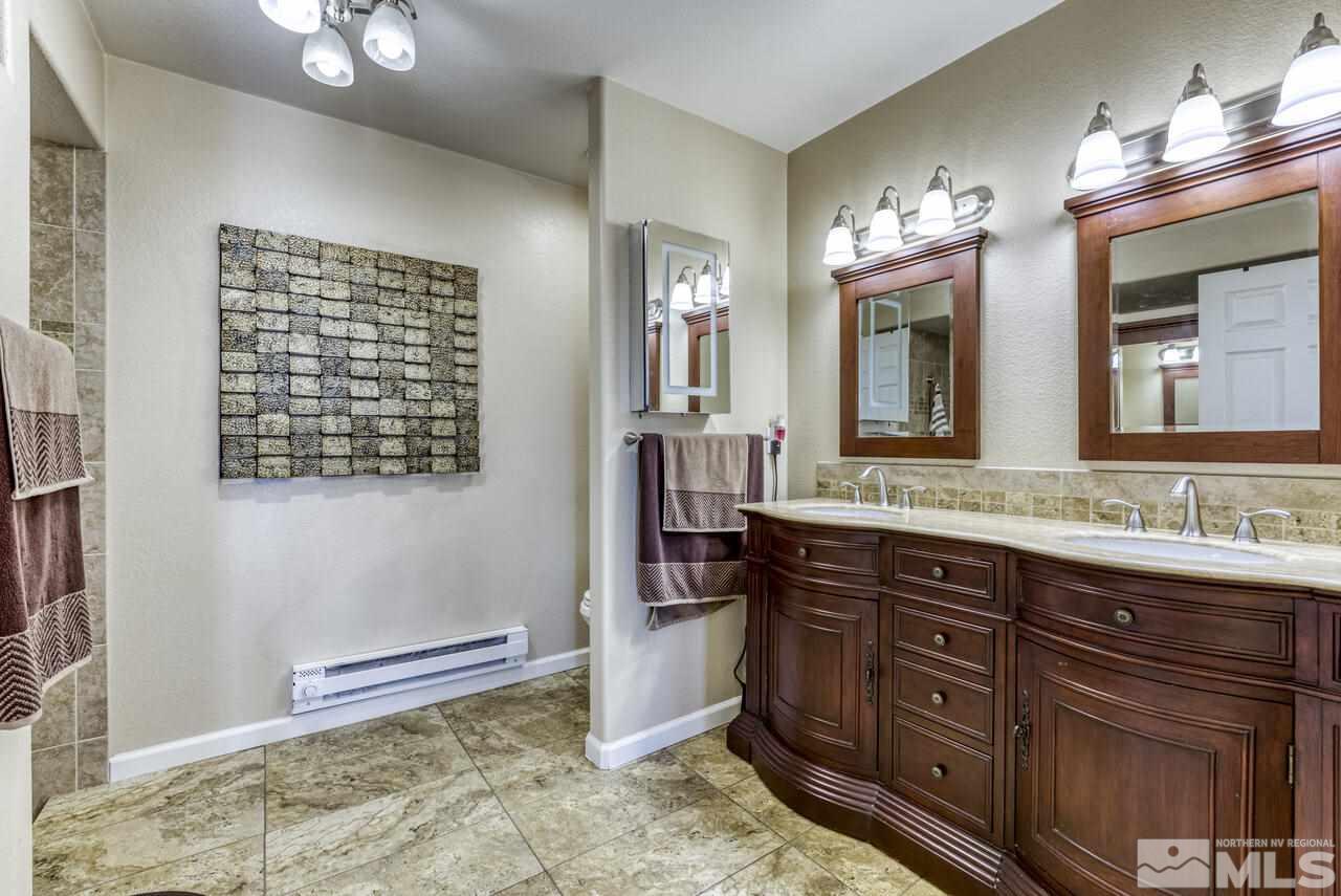 2330 Enterprise Road Reno, NV 89521 - Photo 23 of 40 a spacious bathroom with a granite countertop sink and a mirror