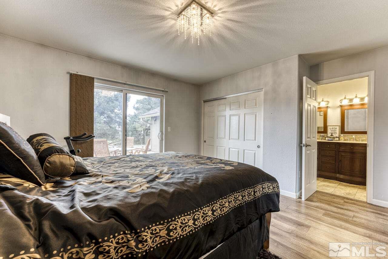 2330 Enterprise Road Reno, NV 89521 - Photo 27 of 40 a bedroom with a bed and wooden floor
