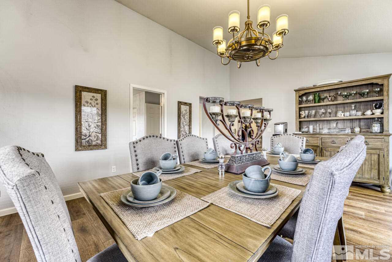 2330 Enterprise Road Reno, NV 89521 - Photo 29 of 40 a view of a dining room with furniture a chandelier and a window