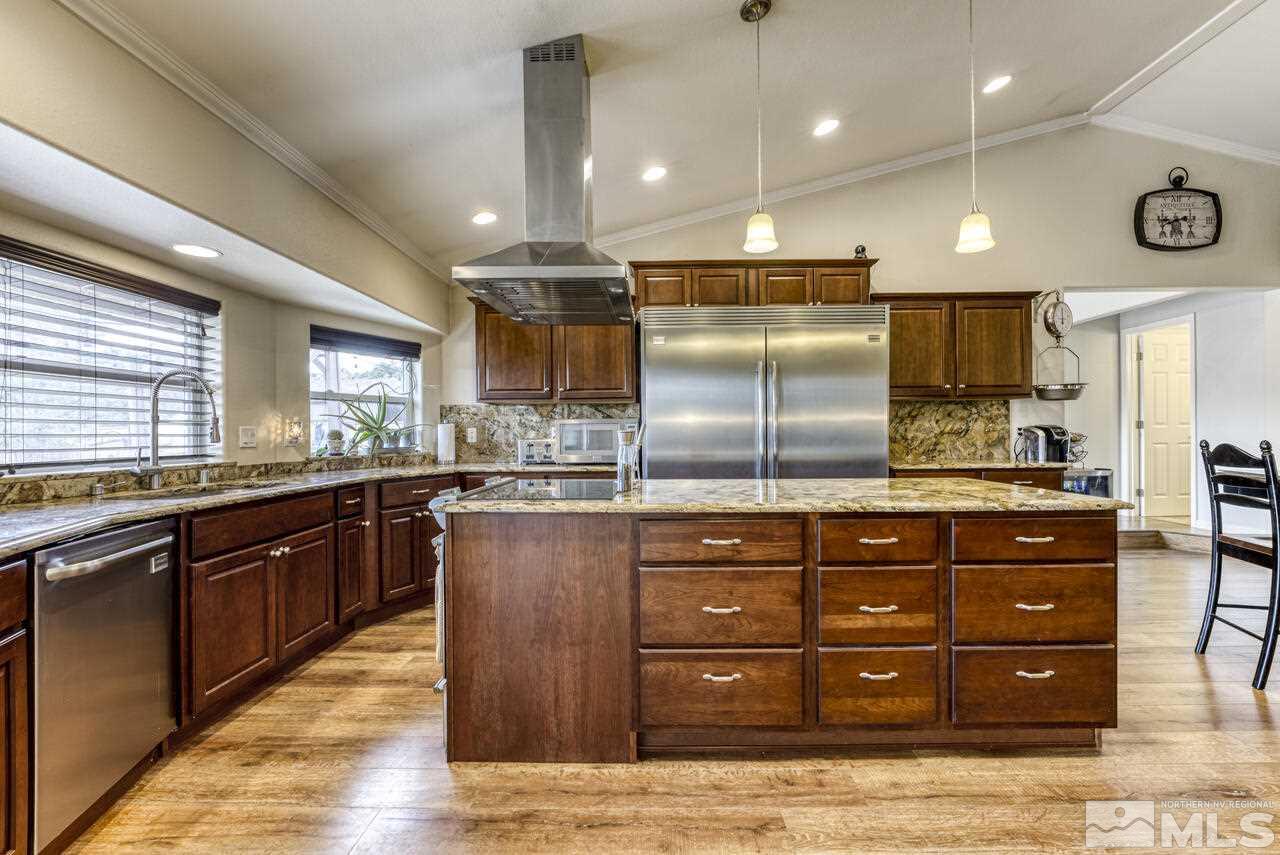 2330 Enterprise Road Reno, NV 89521 - Photo 33 of 40 a kitchen with stainless steel appliances granite countertop wooden cabinets and a sink