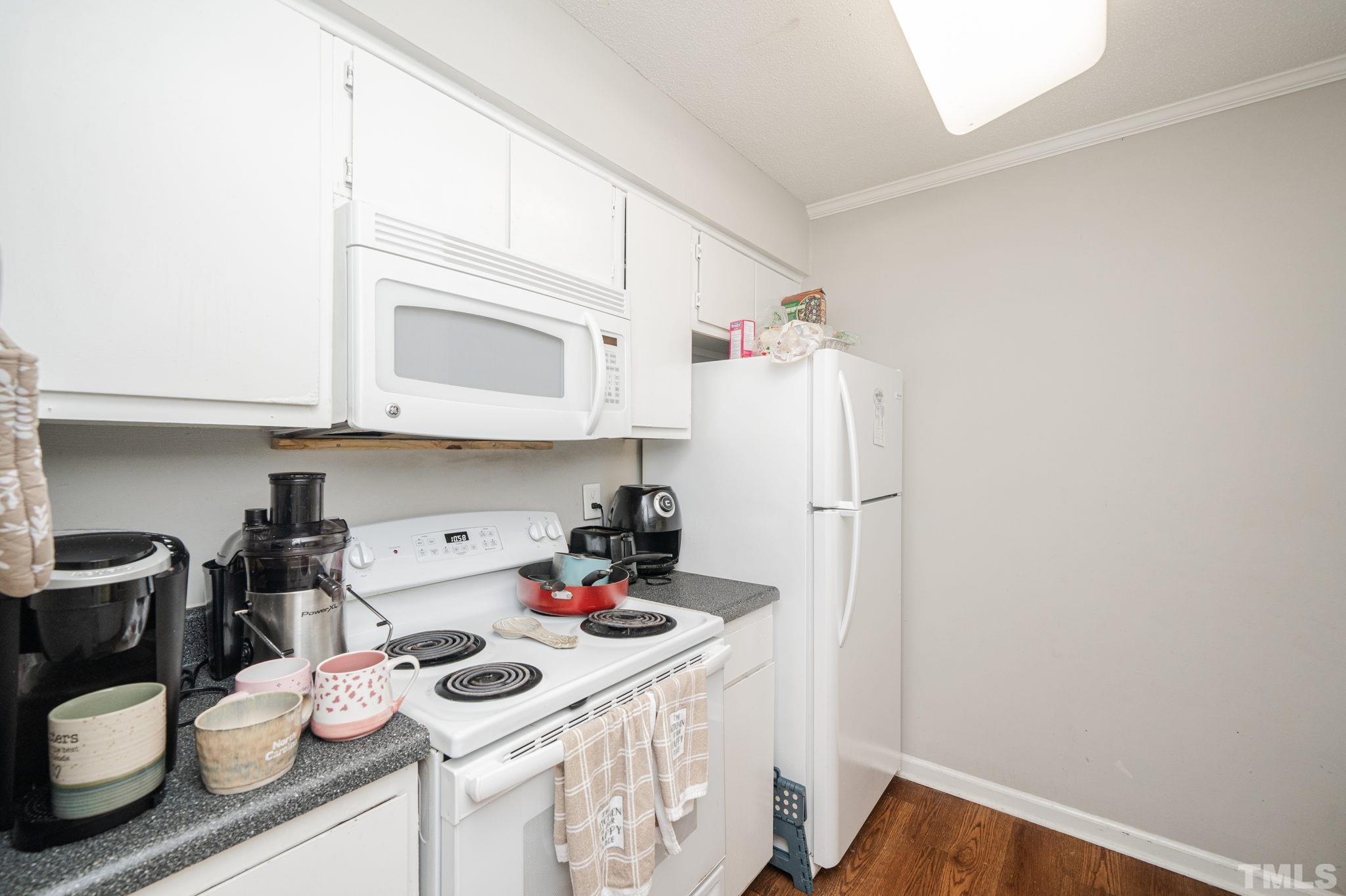 4304 Presley Court Raleigh, NC 27604 - Photo 16 of 34 a kitchen with a sink cabinets and stove top oven