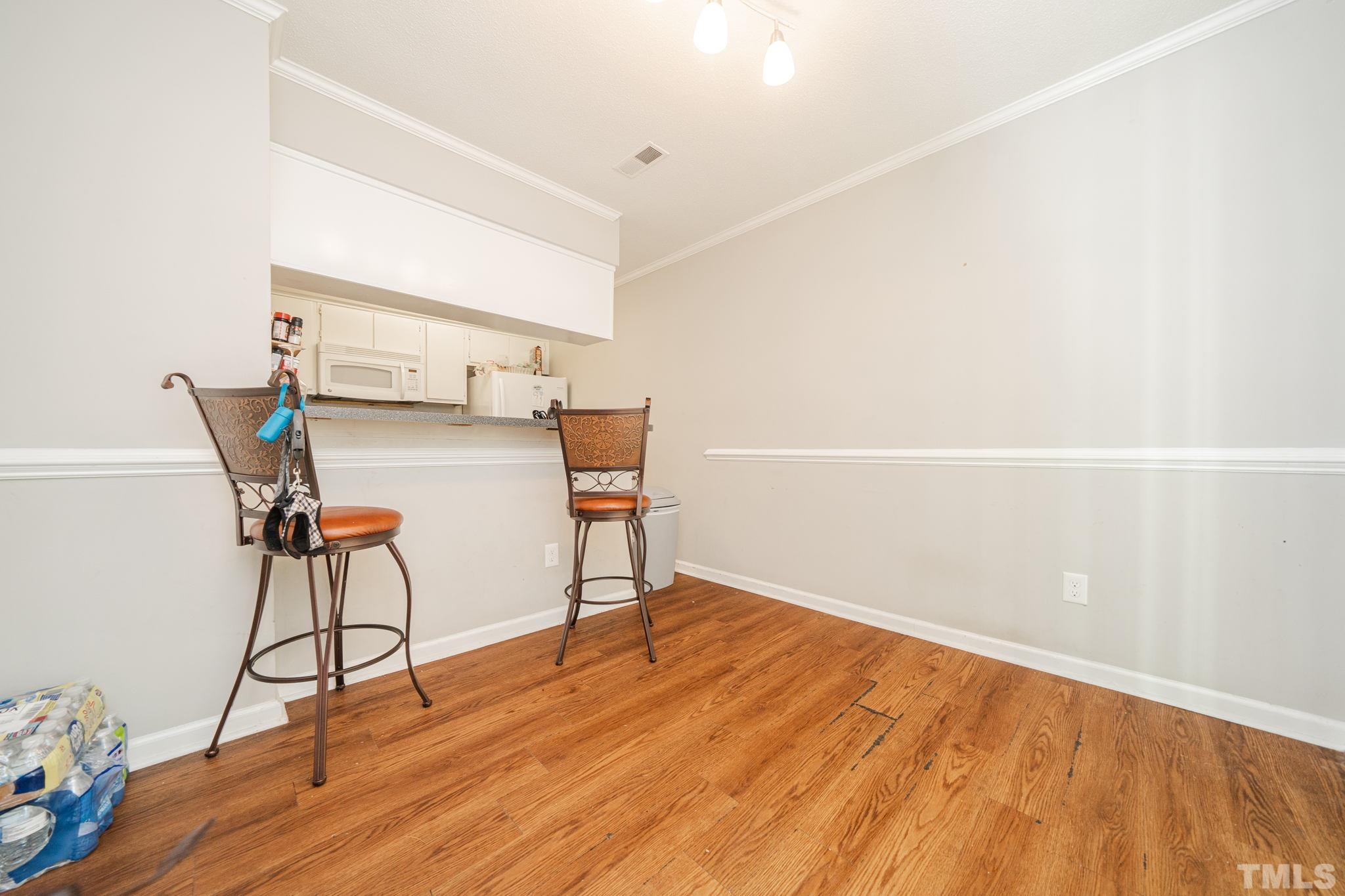 4304 Presley Court Raleigh, NC 27604 - Photo 18 of 34 a view of a room with wooden floor and windows