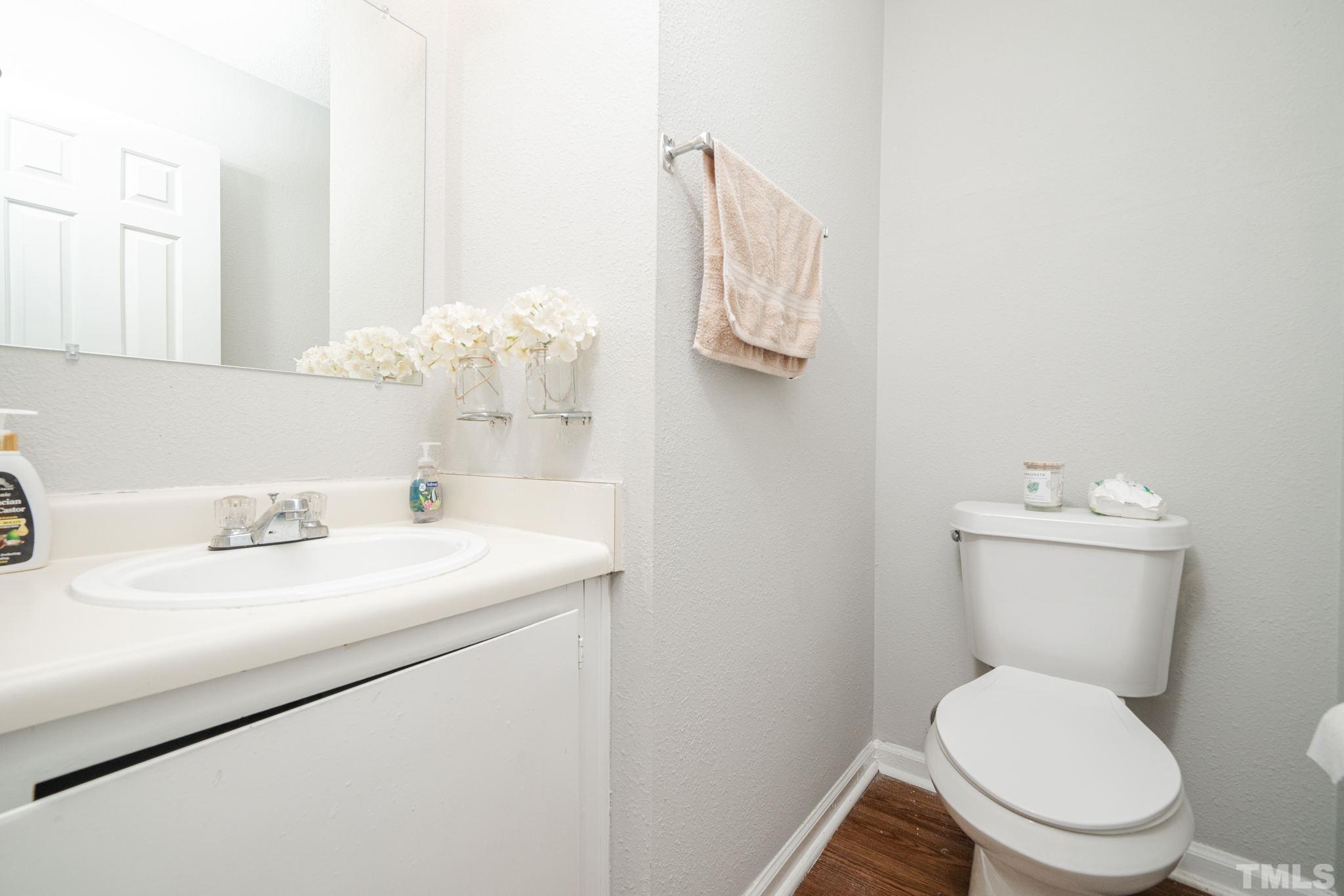 4304 Presley Court Raleigh, NC 27604 - Photo 20 of 34 a bathroom with a toilet sink and mirror