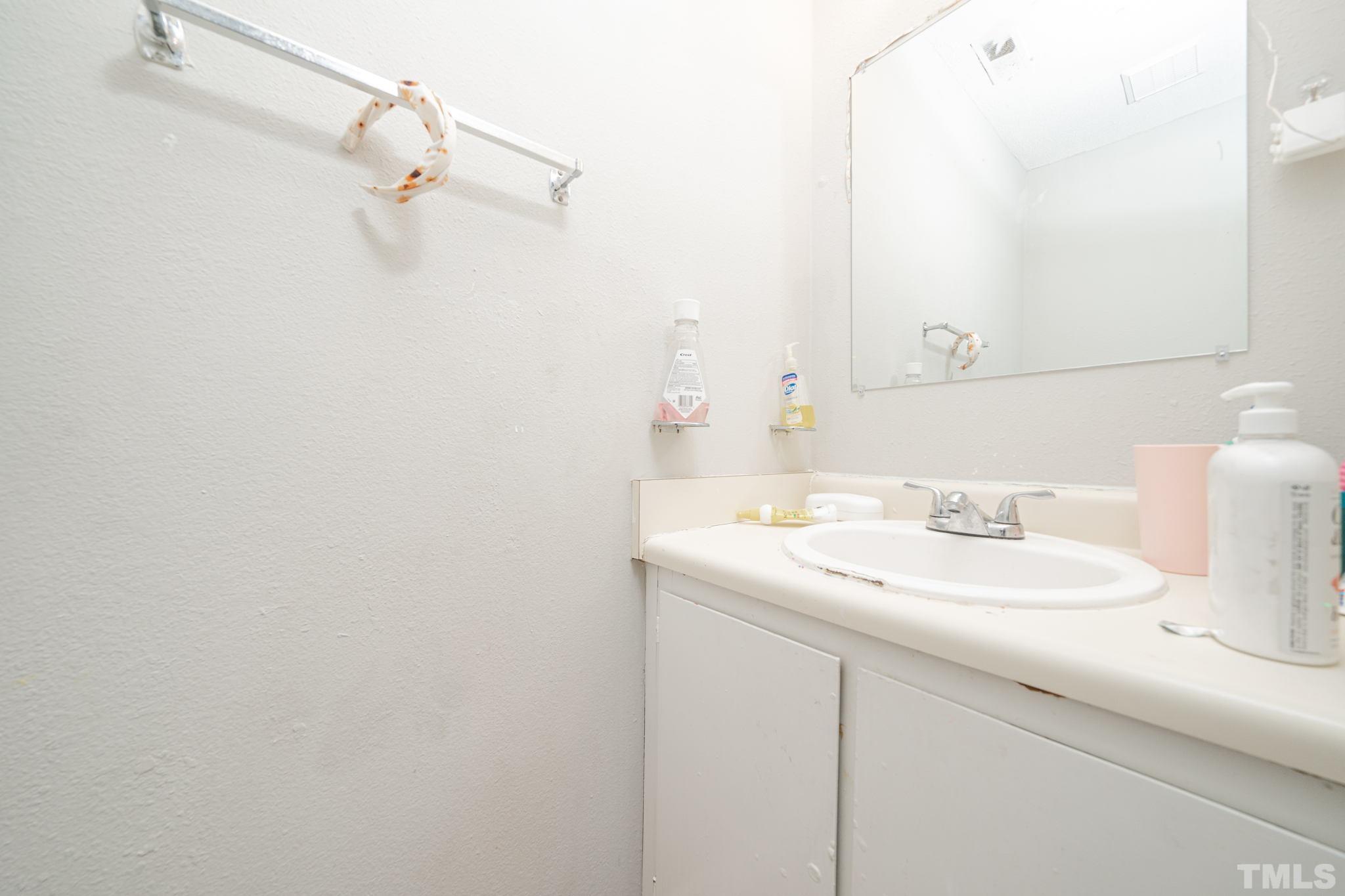 4304 Presley Court Raleigh, NC 27604 - Photo 22 of 34 a bathroom with a sink and a mirror