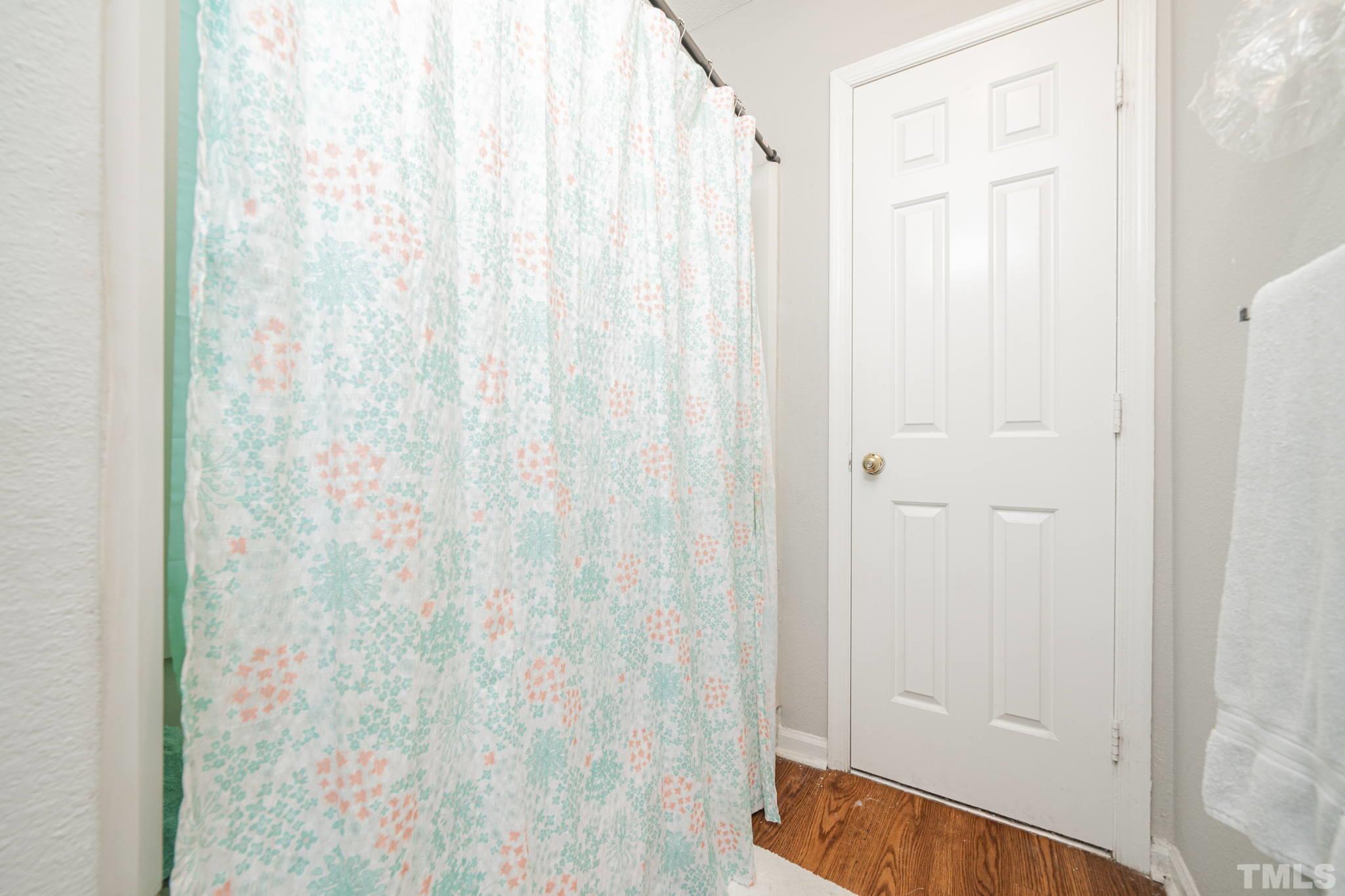 4304 Presley Court Raleigh, NC 27604 - Photo 23 of 34 a bathroom with a shower curtain and a shower curtain