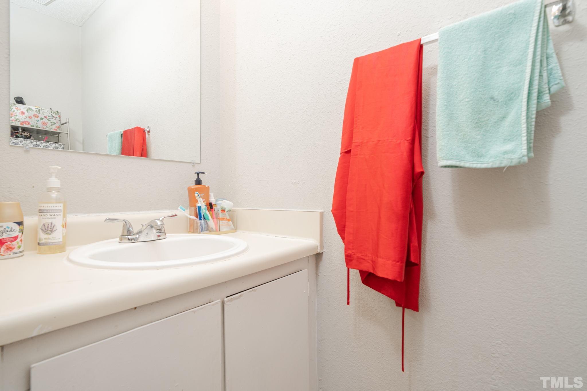 4304 Presley Court Raleigh, NC 27604 - Photo 24 of 34 a bathroom with a sink and a mirror
