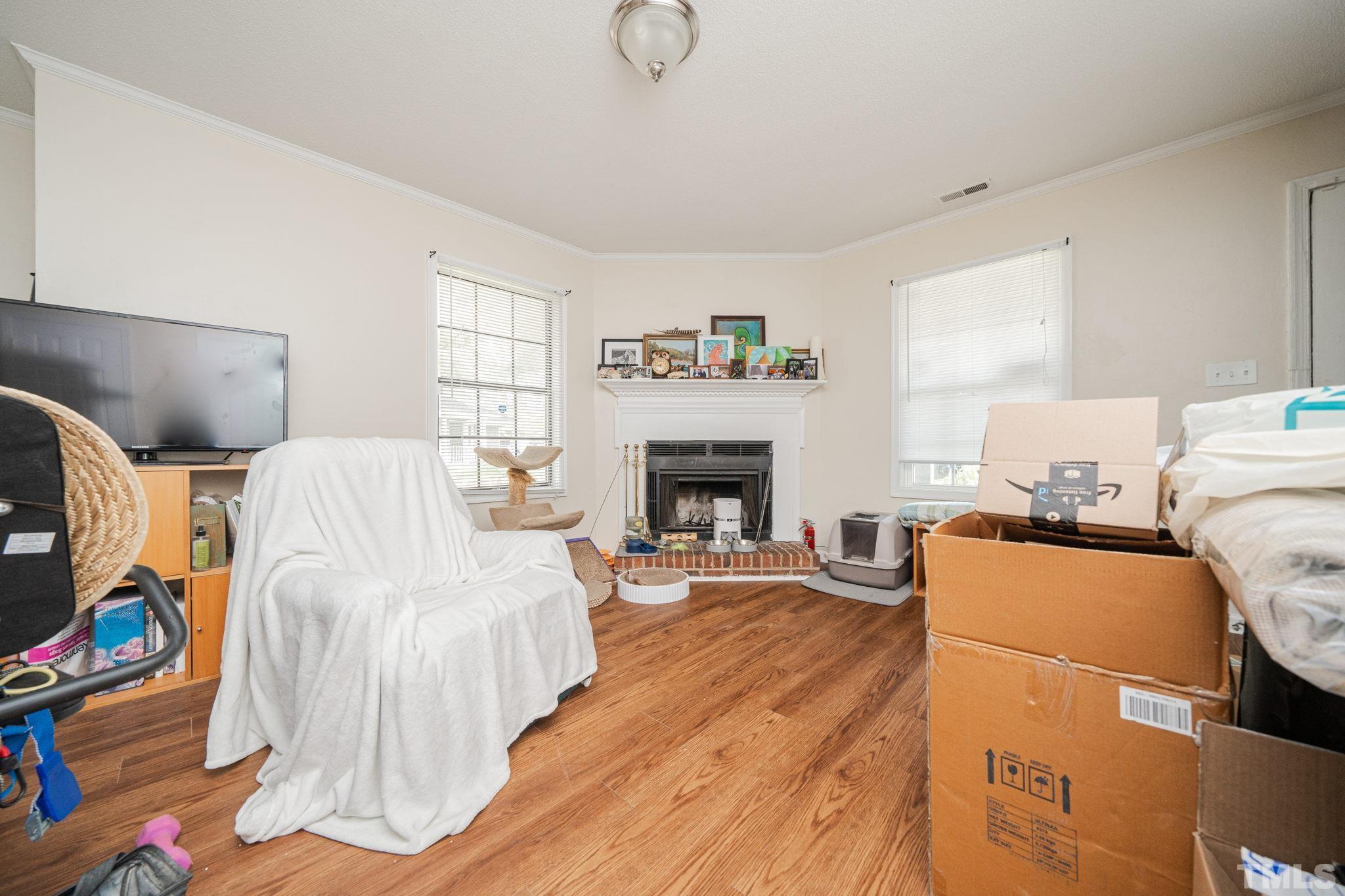 4304 Presley Court Raleigh, NC 27604 - Photo 26 of 34 a bedroom with furniture and a fireplace