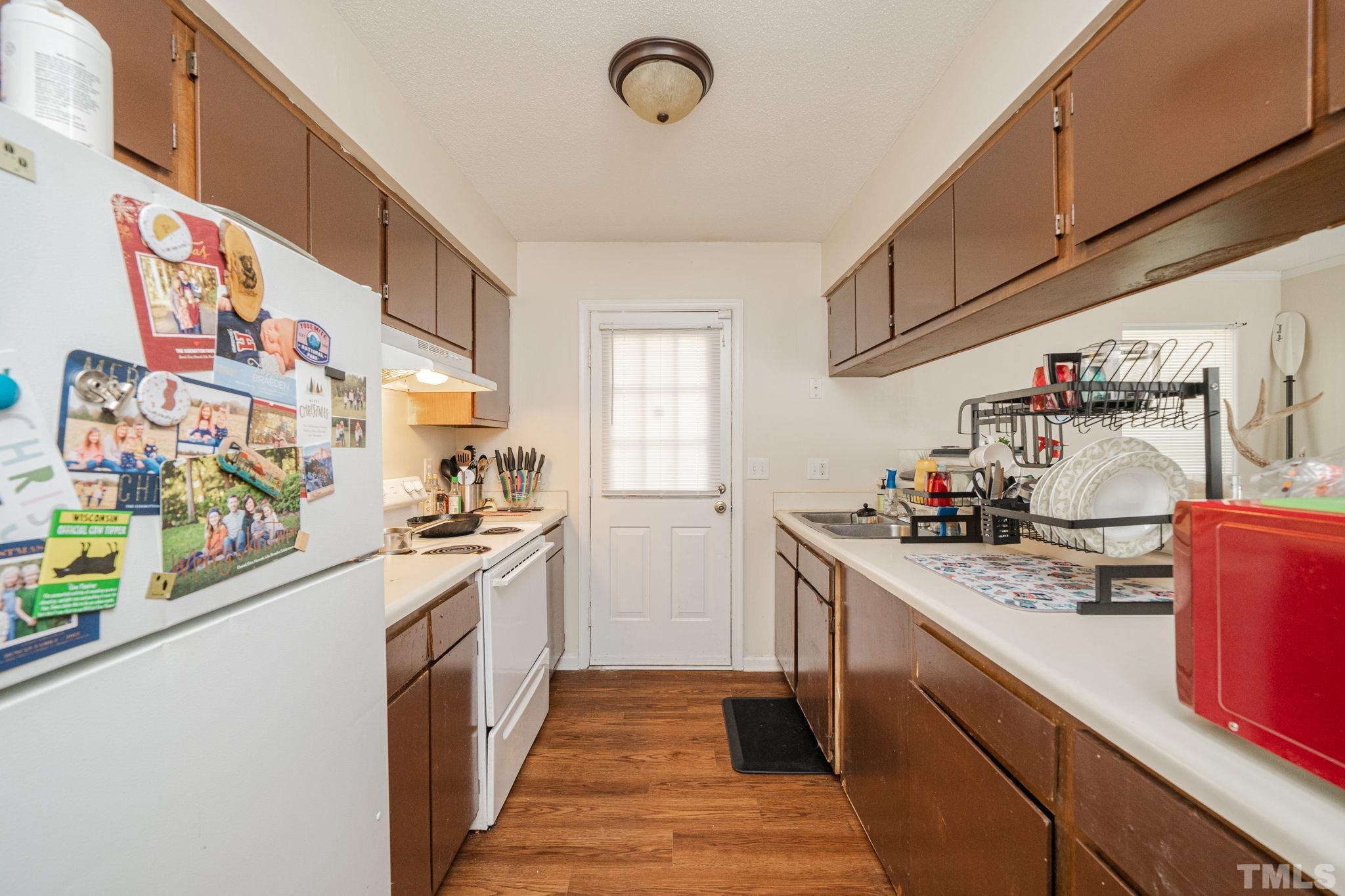 4304 Presley Court Raleigh, NC 27604 - Photo 27 of 34 a kitchen with stainless steel appliances granite countertop a sink and cabinets