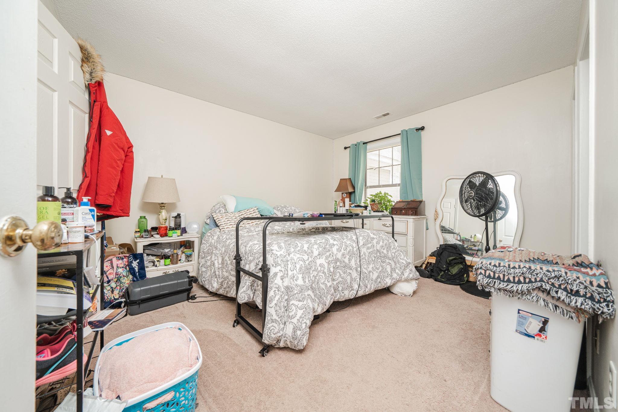 4304 Presley Court Raleigh, NC 27604 - Photo 30 of 34 a bedroom with a bed and a window