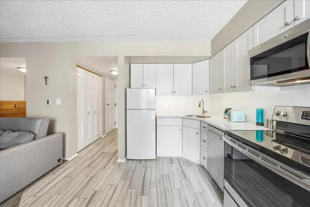 a kitchen with cabinets oven and a dishwasher