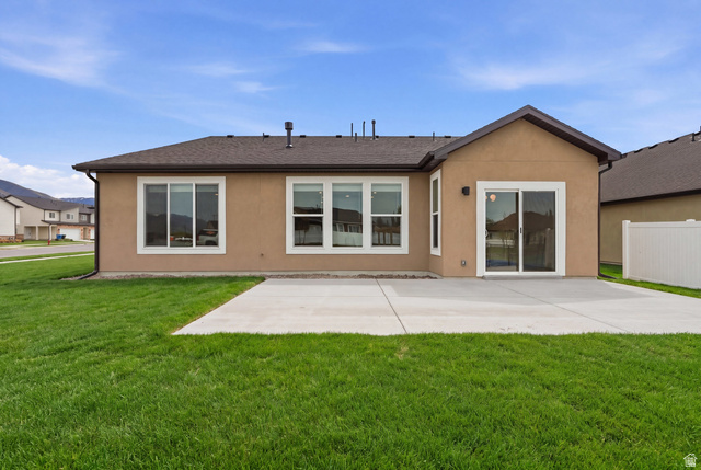 401 West 3085 South, Unit 329 Nibley, UT 84321 - Photo 26 of 34 Back of house with stucco siding and roof with shingles