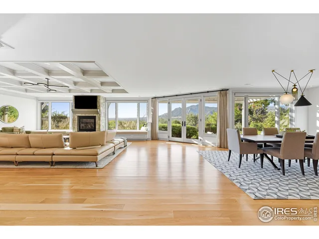 a living room with fireplace furniture and a large window