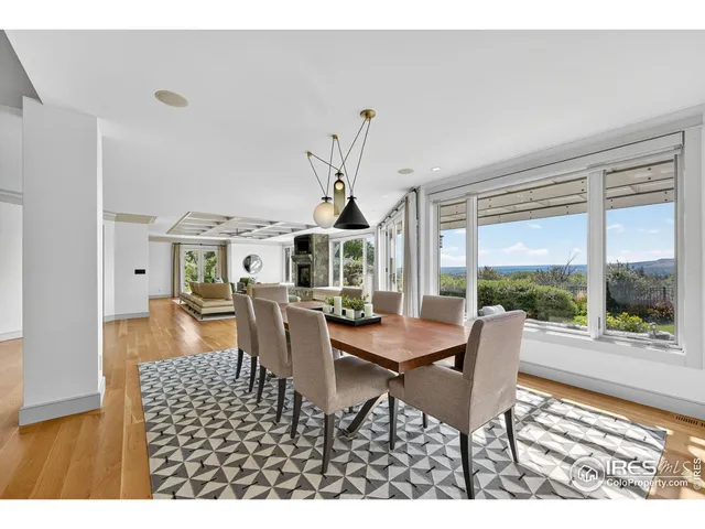 a dining room with furniture wooden floor and a rug