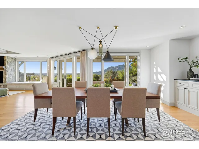 a dining room with furniture a chandelier and wooden floor