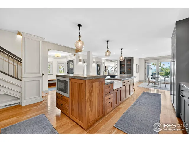 a open kitchen with cabinets a stove and a wooden floors