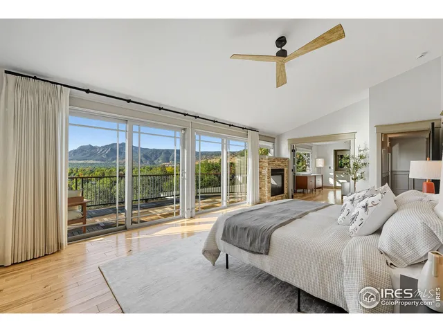 a bedroom with a large bed and a large window