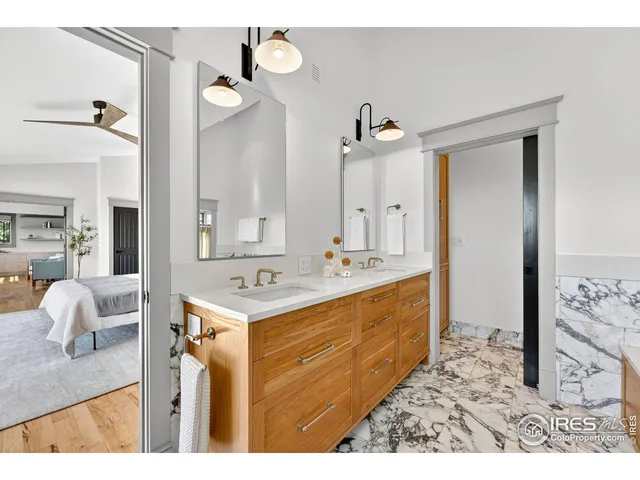 a bathroom with a sink vanity granite tub and a mirror