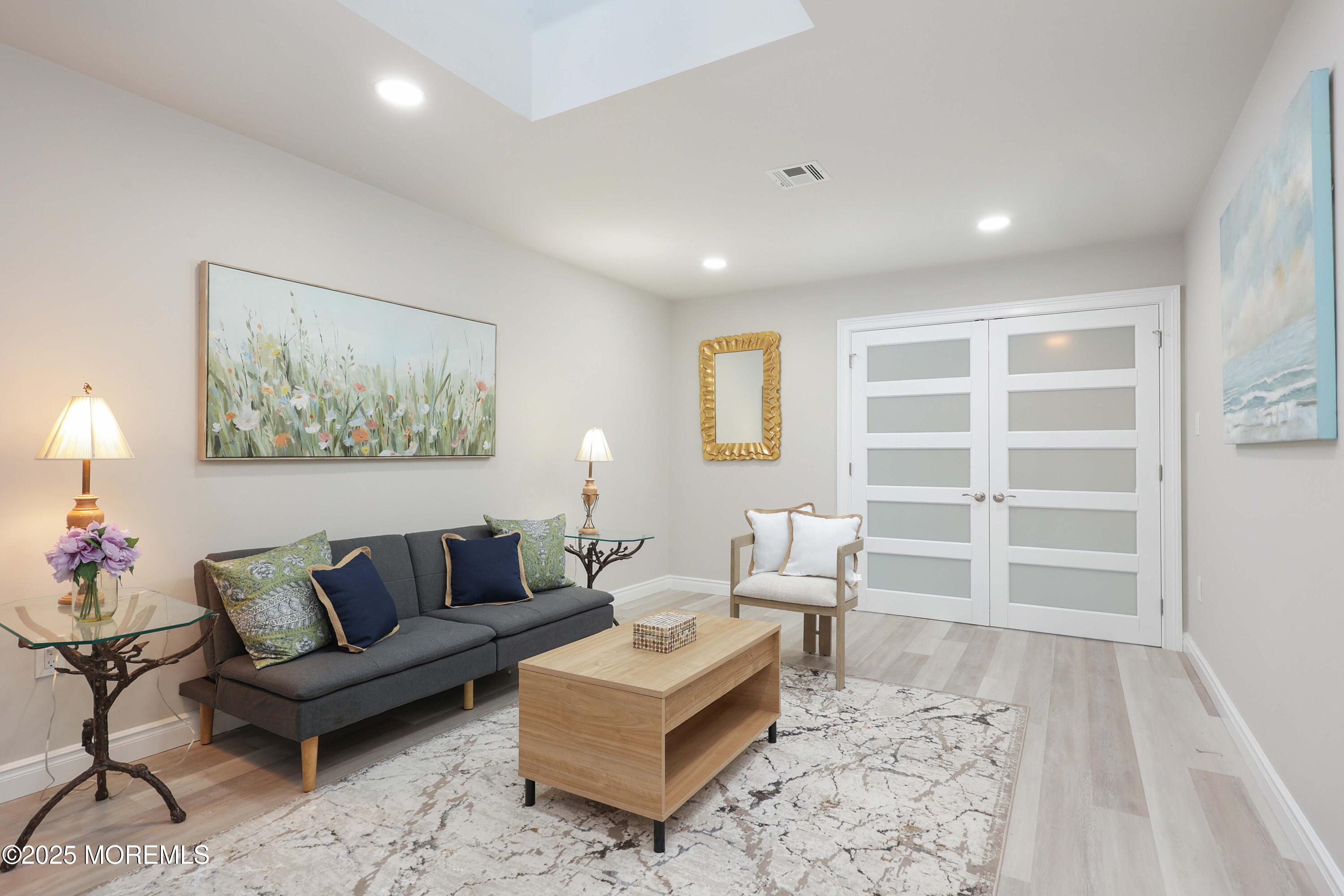 12 Ellsworth Court Red Bank, NJ 07701 - Photo 16 of 54 a living room with furniture and a painting on the wall