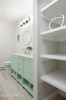 a bathroom with a double vanity sink mirror and toilet