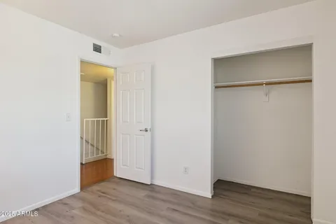 a bedroom with a bed and a painting on the wall