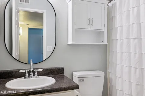 a view of an empty room with wooden floor and closet