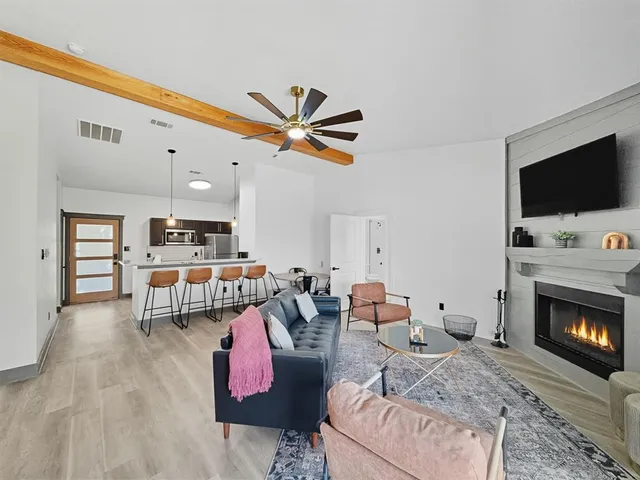 a kitchen with a table chairs and wooden floor
